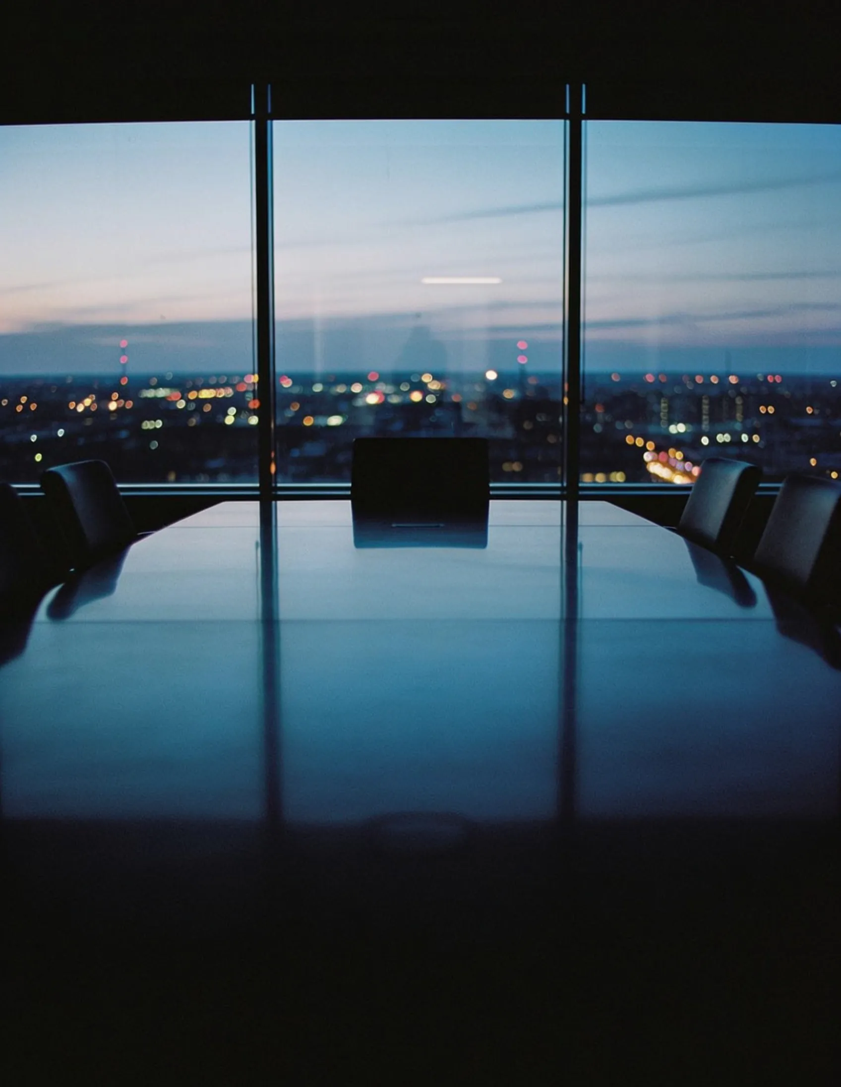 Modern corporate boardroom at twilight